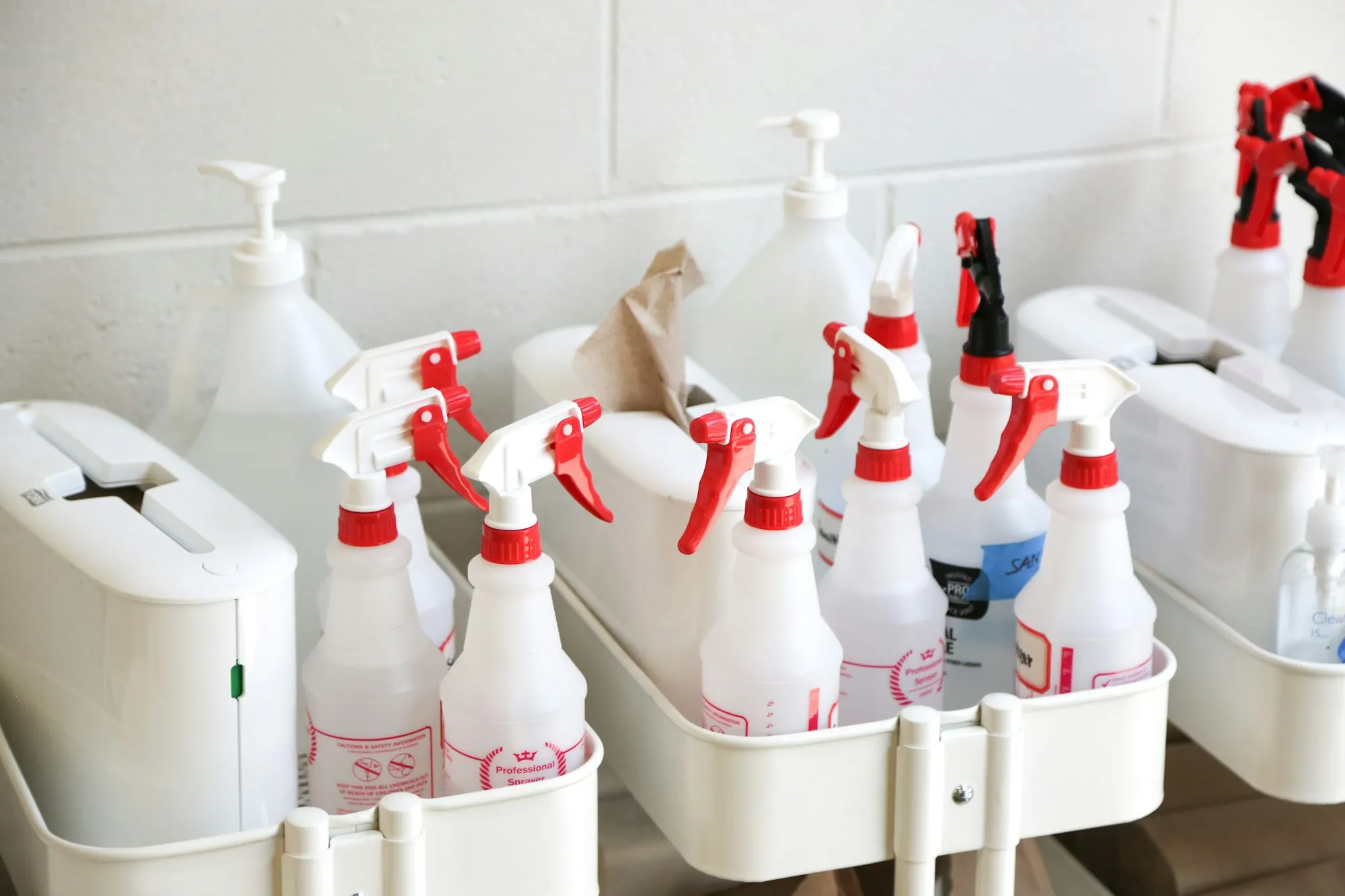 Caddies of spray bottles and cleaning supplies