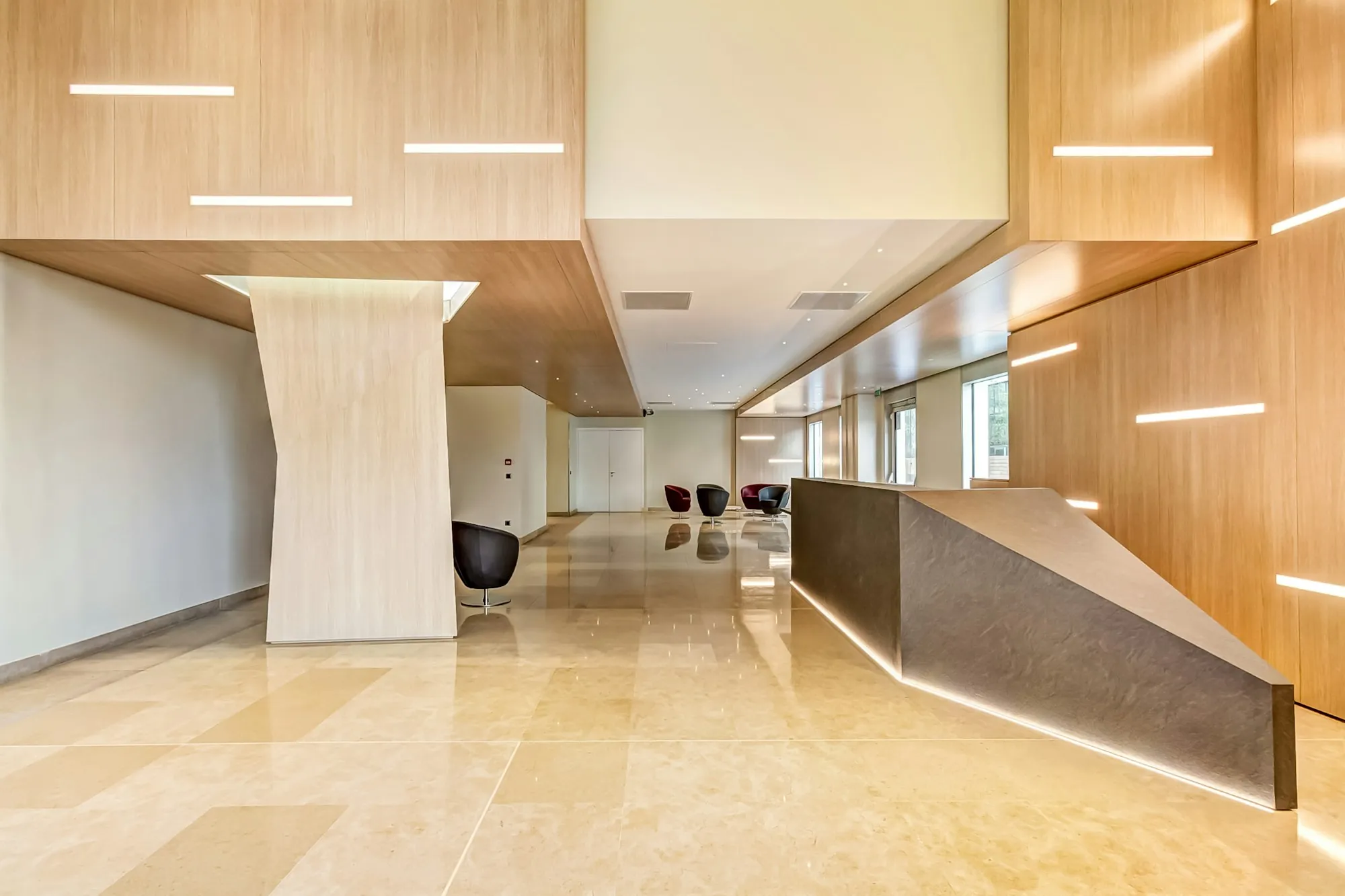 Reception area with a light wood desk and polished floor