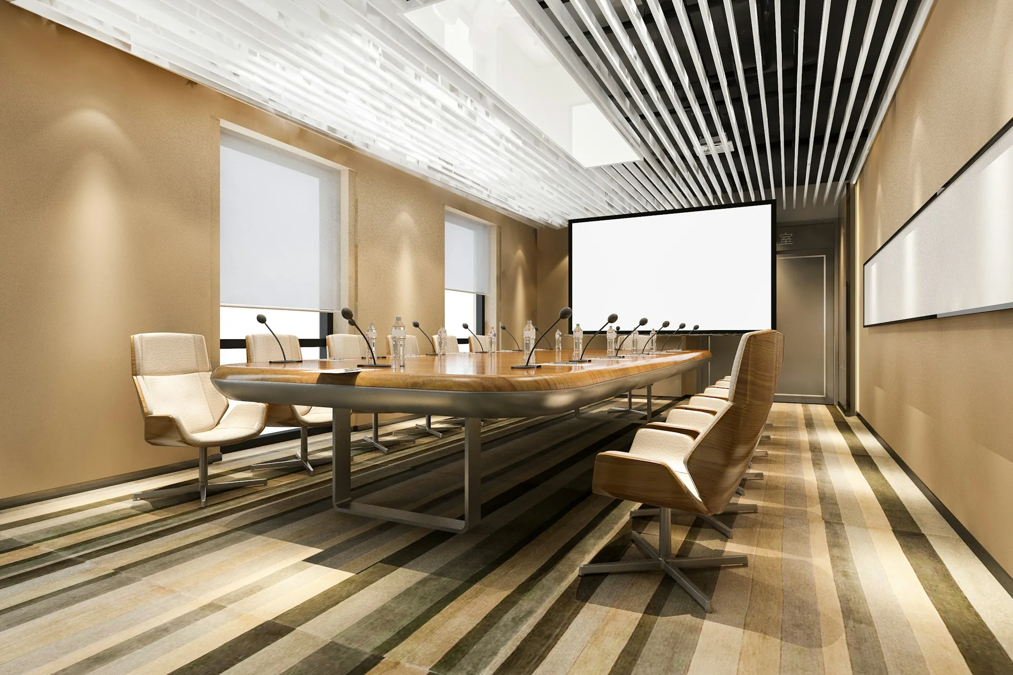 Long boardroom with white chairs and a projector screen