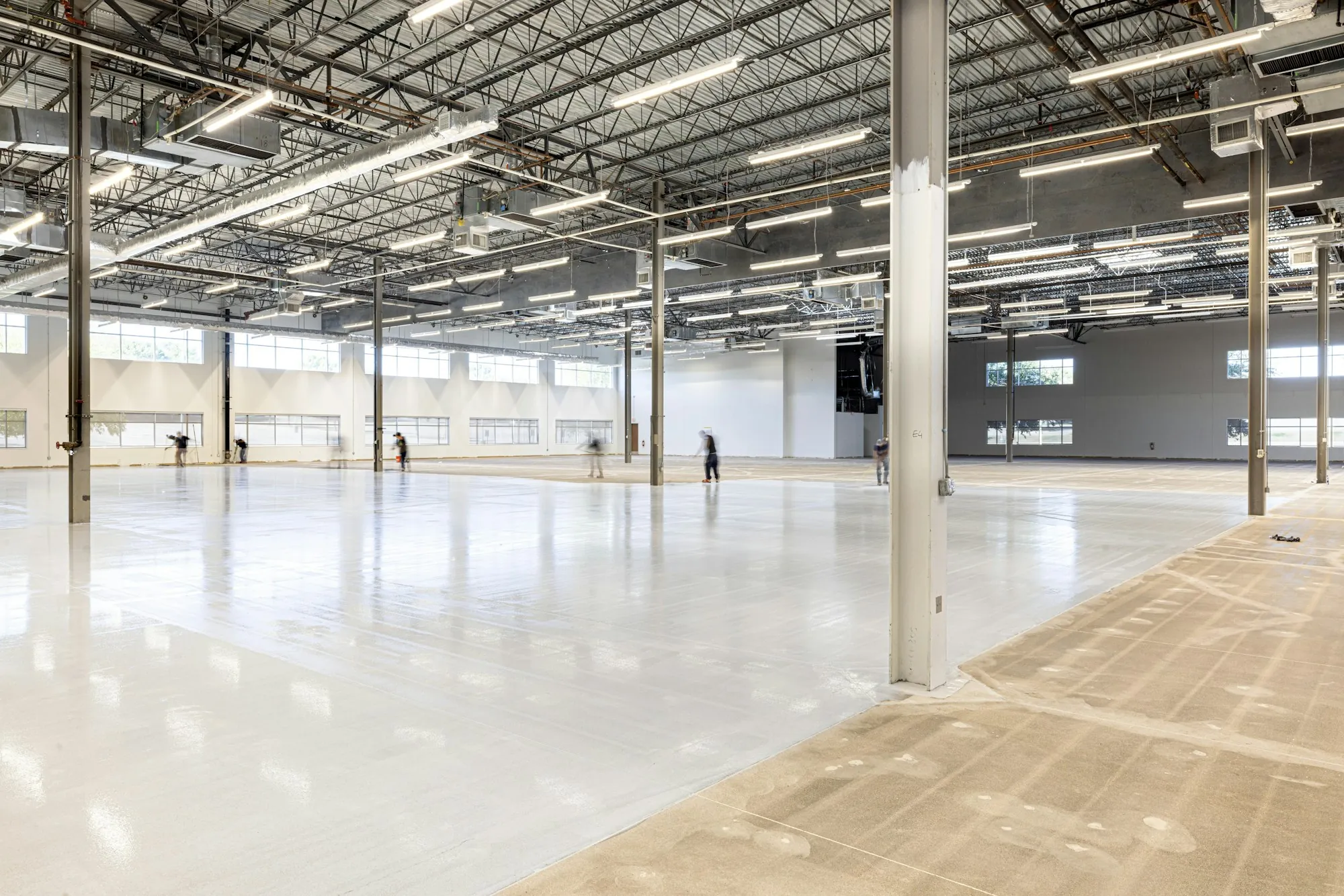 Empty warehouse bay with a bright concrete floor